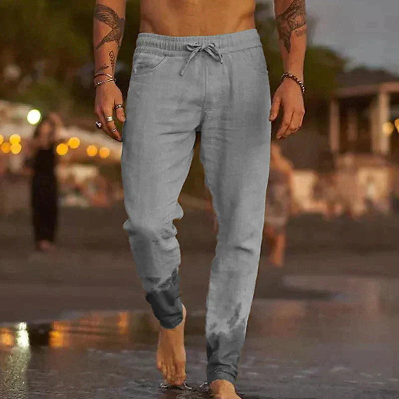 "Pantalon en lin léger pour homme, coupe ample, taille élastique, poches plaquées, couleurs variées, style décontracté."