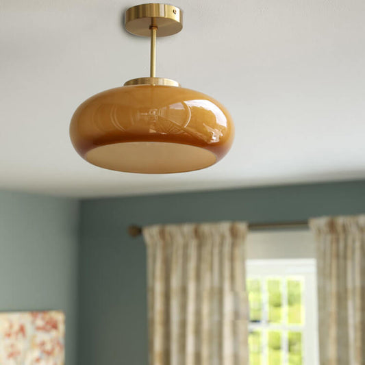 "Plafonnier vintage en laiton et verre jaune, design semi-flottant, éclairage doux, style rétro élégant pour intérieur."