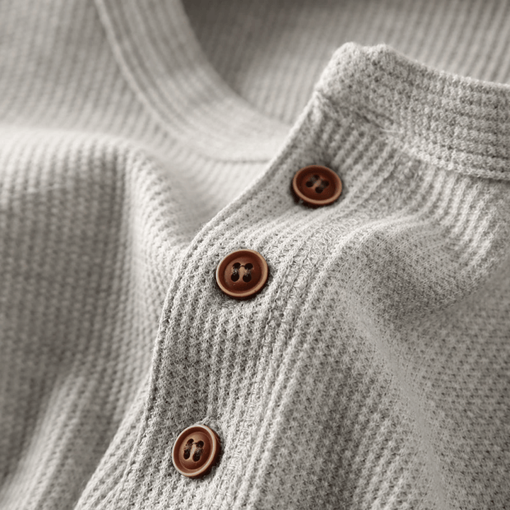 "Pull Henley homme en coton doux, couleur neutre, design moderne avec col Henley, pour style chic et confortable."