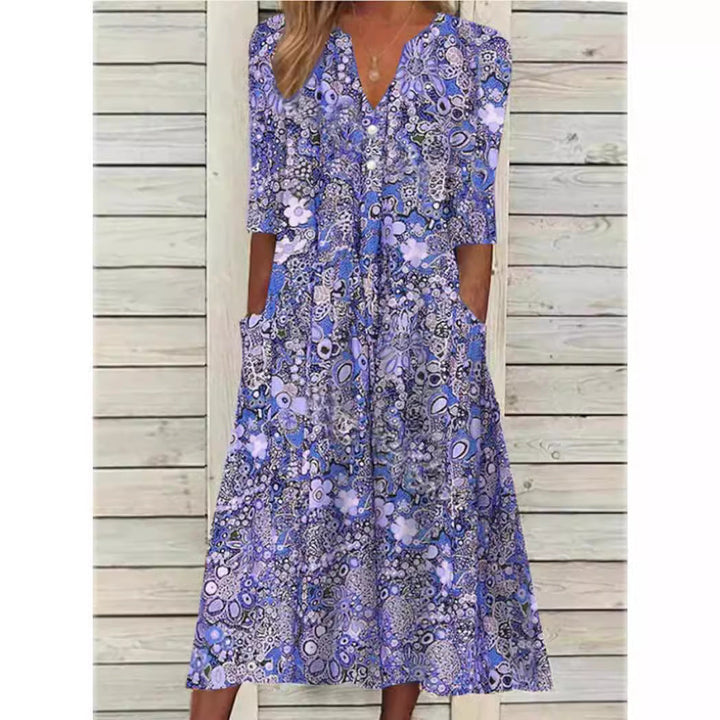 Robe chemise florale élégante Andrea, coupe flatteuse, fond blanc, fleurs colorées, polyvalente et confortable.