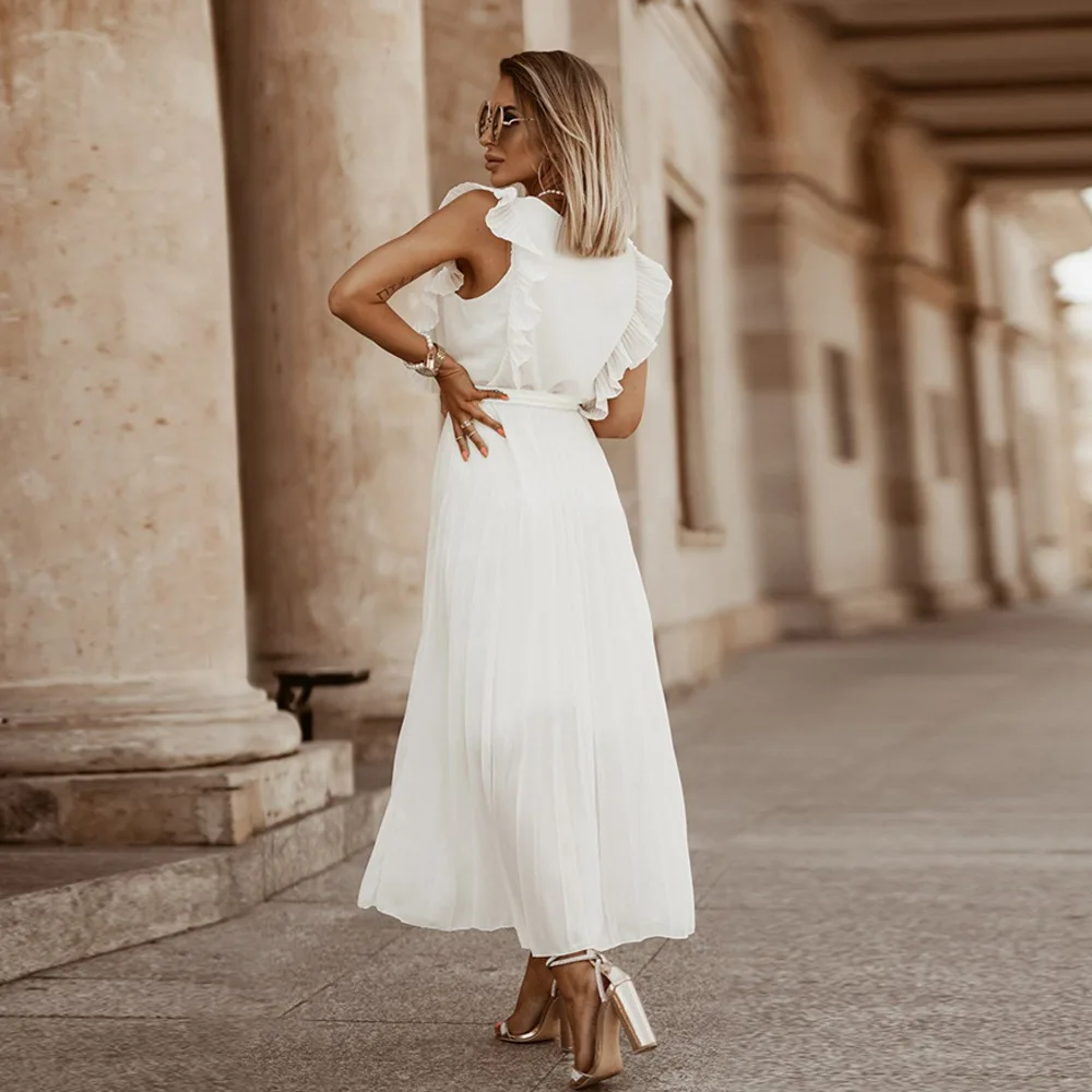 Robe de mariée bohème fluide à volants élégants, coupe maxi, détails raffinés et chic pour mariages et occasions uniques.