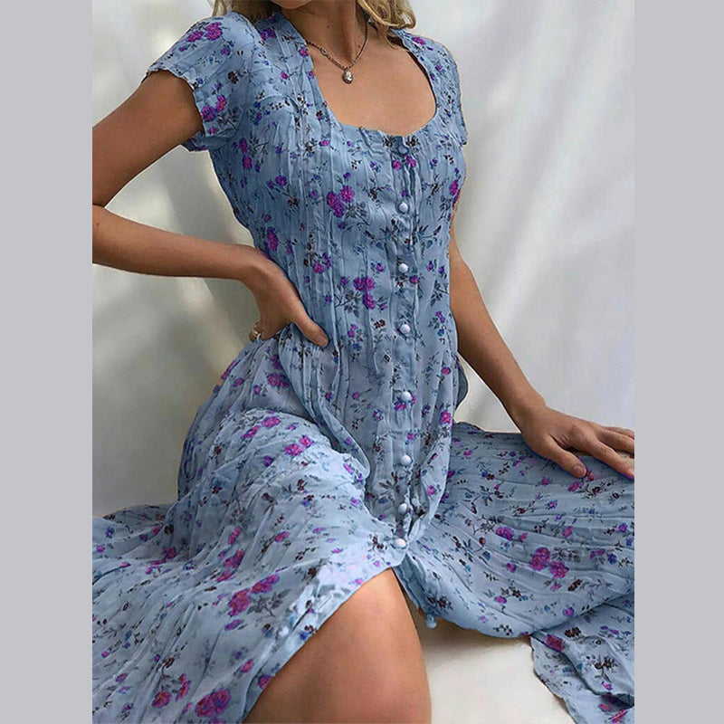 "Robe d'été fleurie Elvira élégante et aérienne, imprimé floral charmant, coupe fluide et flatteuse idéale pour l'été."