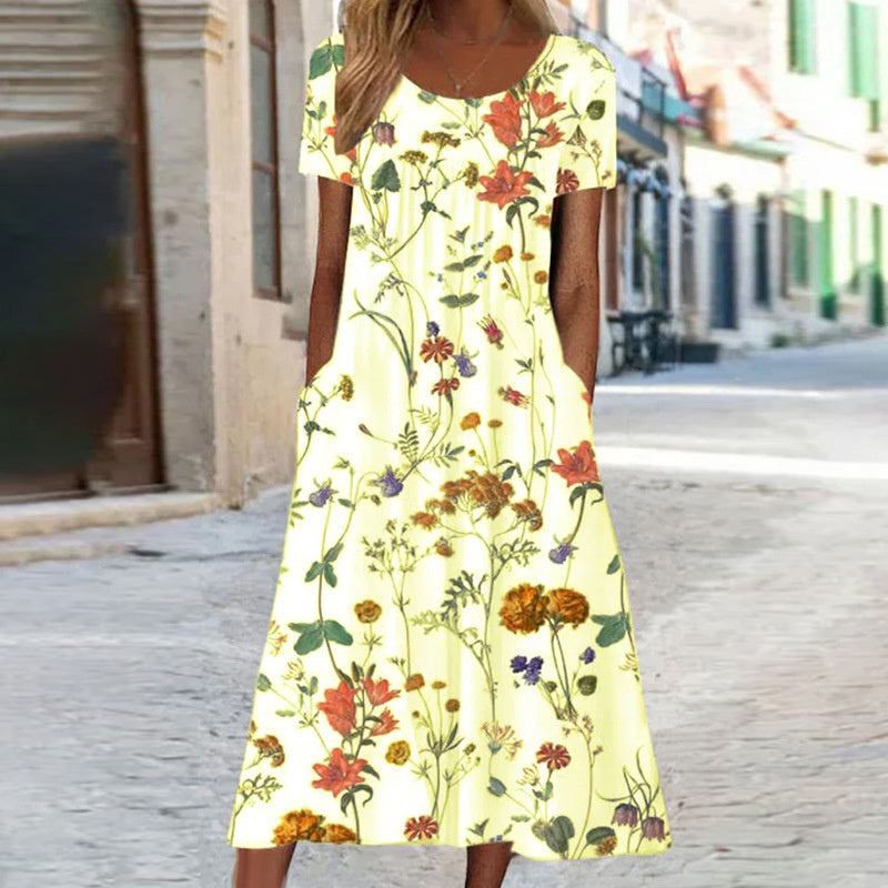 "Robe d'été fluide avec motifs floraux turquoise et blancs, coupe bohème chic, manches courtes, idéale pour l'été."