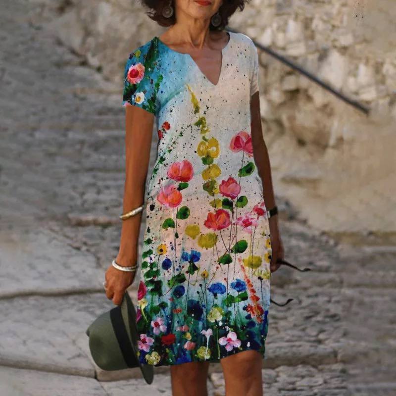 Robe d'été légère pour femme, imprimé floral coloré, tissu fluide, élégante pour journées chaudes et occasions décontractées.