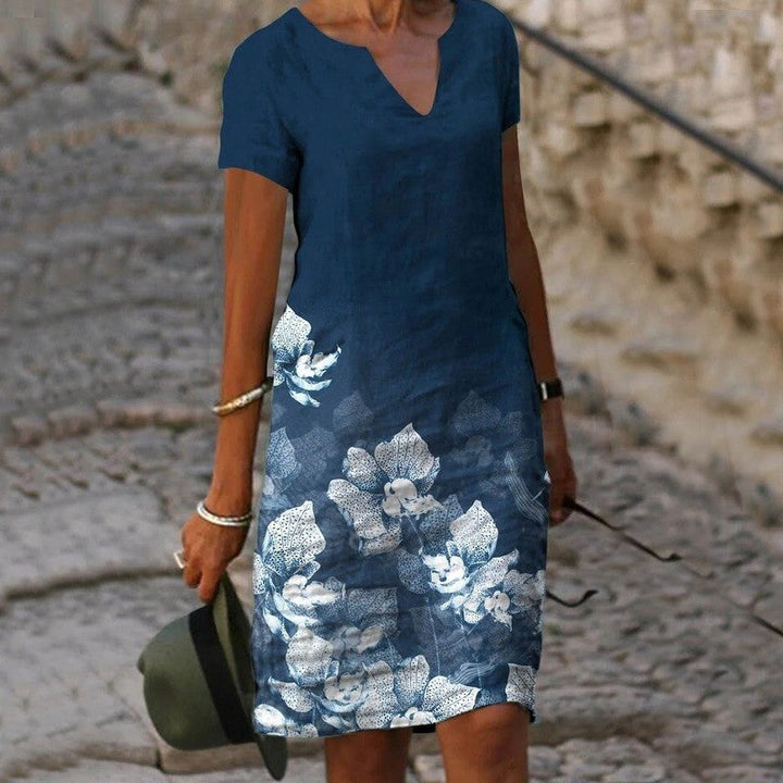 Robe d'été légère pour femme, imprimé floral coloré, tissu fluide, élégante pour journées chaudes et occasions décontractées.