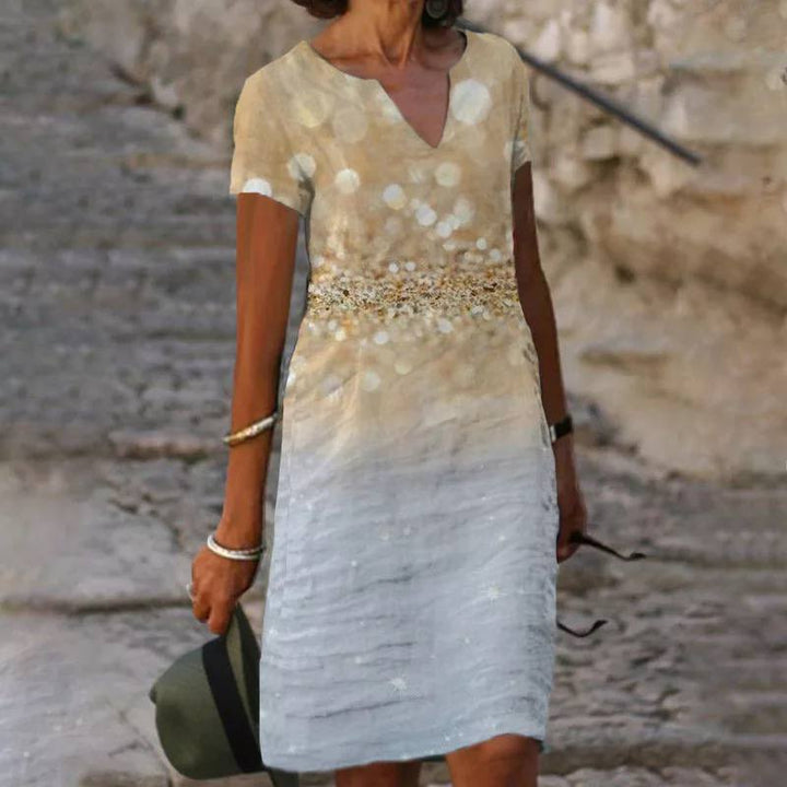 Robe d'été légère pour femme, imprimé floral coloré, tissu fluide, élégante pour journées chaudes et occasions décontractées.