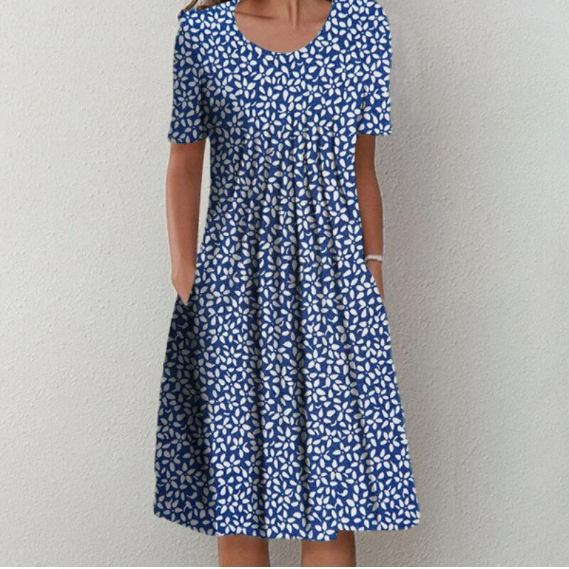 Robe élégante Margaux avec motifs floraux et à pois, chic et polyvalente pour femmes, coloris bleu marine et noir.