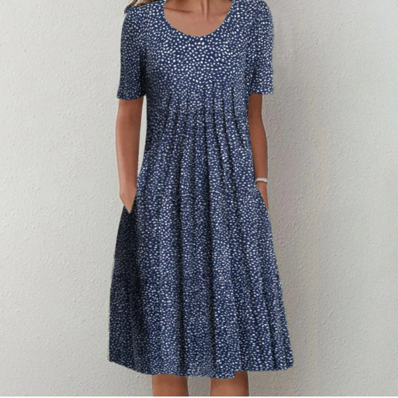 Robe élégante Margaux avec motifs floraux et à pois, chic et polyvalente pour femmes, coloris bleu marine et noir.