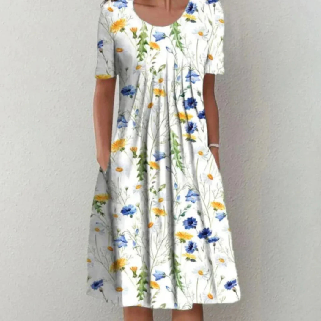 "Robe fleurie midi femme, manches courtes, imprimé coloré pour une allure estivale fraîche et confortable."