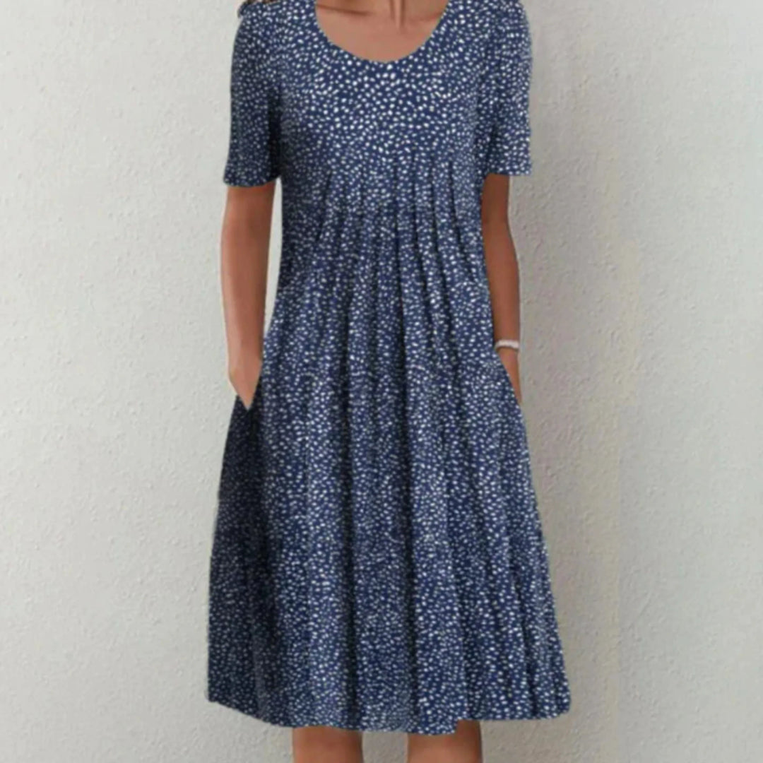 "Robe fleurie midi femme, manches courtes, imprimé coloré pour une allure estivale fraîche et confortable."