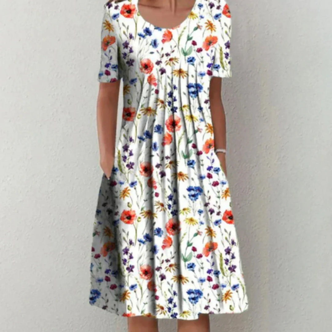 "Robe fleurie midi femme, manches courtes, imprimé coloré pour une allure estivale fraîche et confortable."
