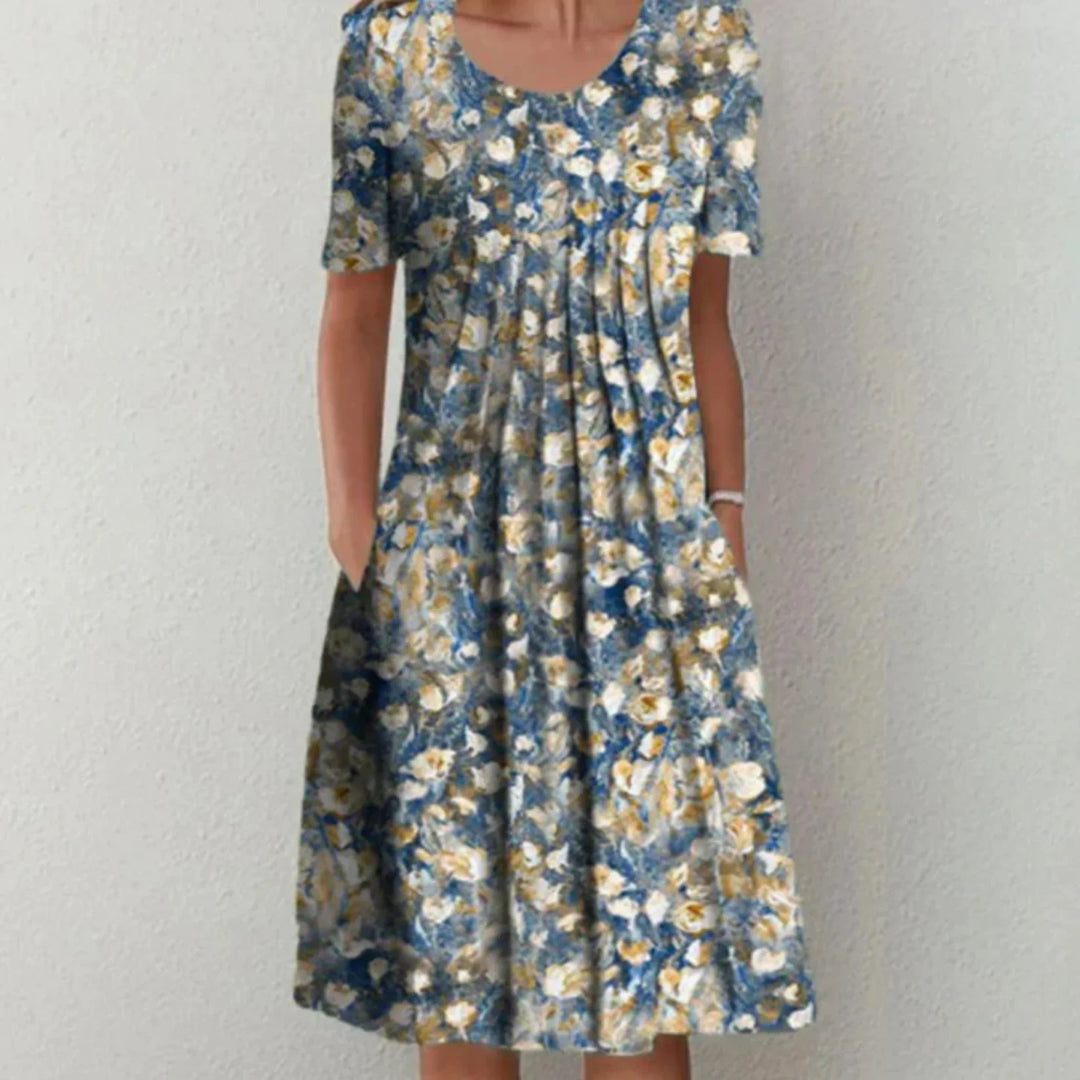 "Robe fleurie midi femme, manches courtes, imprimé coloré pour une allure estivale fraîche et confortable."