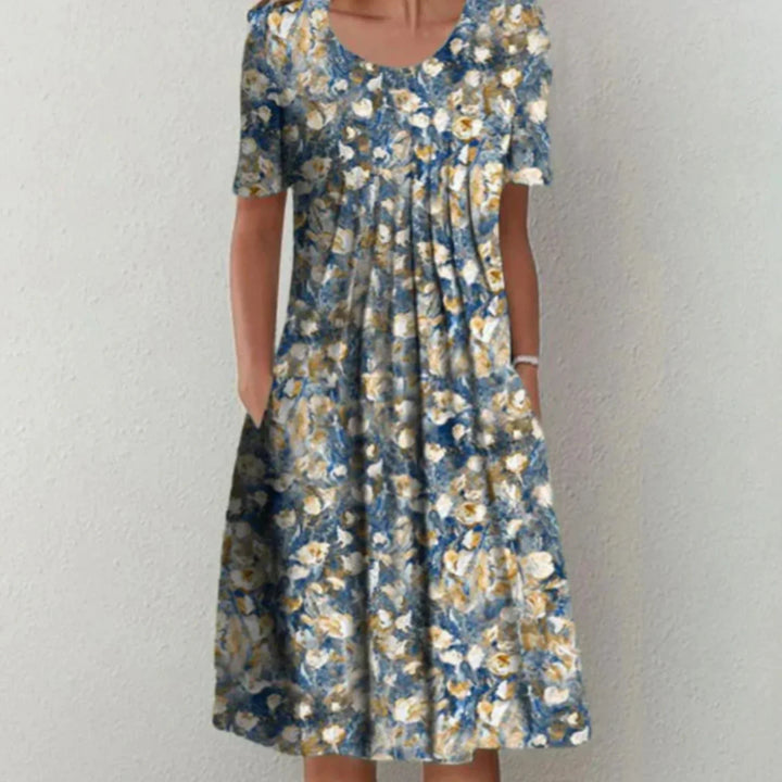 "Robe fleurie midi femme, manches courtes, imprimé coloré pour une allure estivale fraîche et confortable."