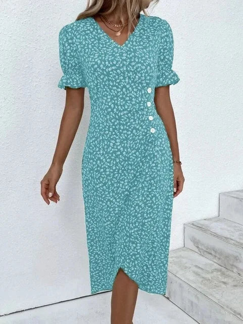 "Robe Isabelle fleurie élégante, motifs floraux colorés, manche courte, coupe ajustée féminine, idéale bureau ou soirée."