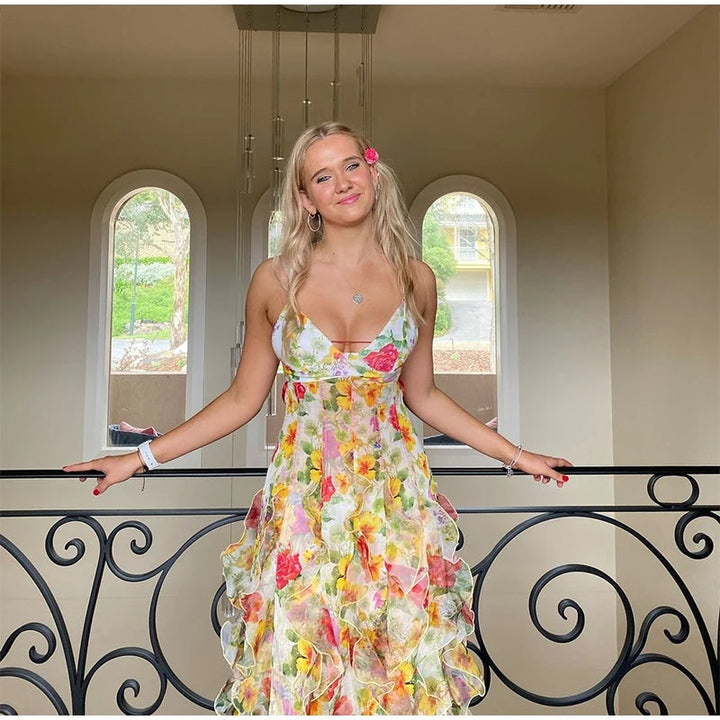 Robe longue à volants et motif floral, élégante et féminine, parfaite pour l'été, avec bretelles fines et volants superposés.