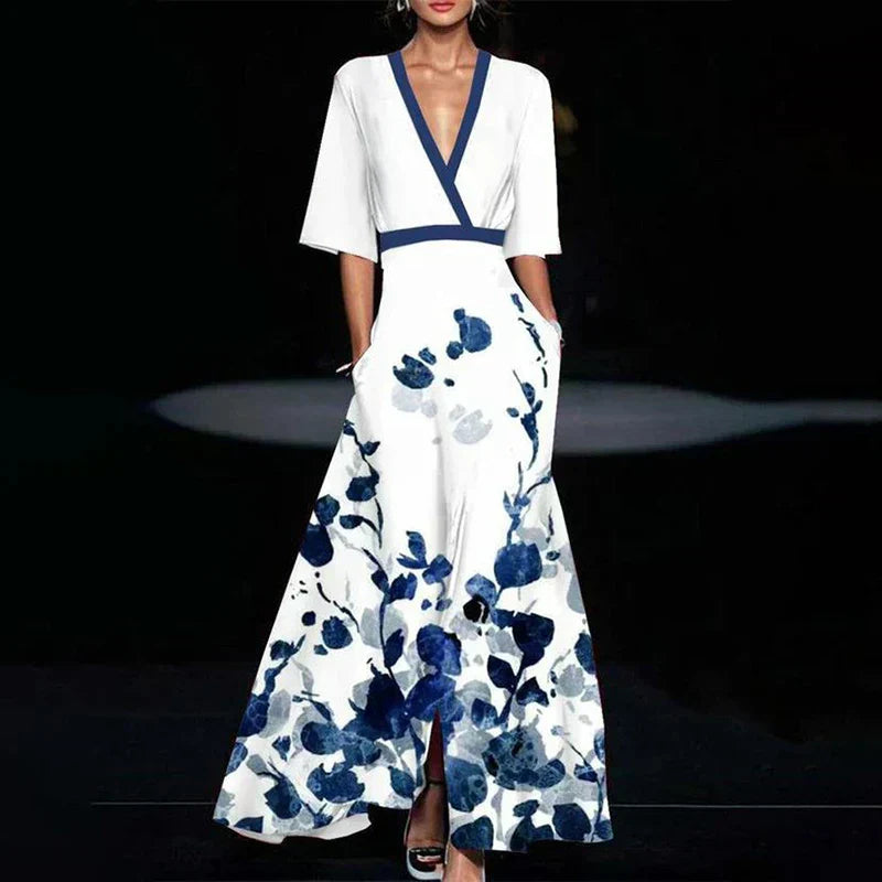 "Robe maxi longue élégante à imprimé floral vibrant, col en V et manches trois-quarts, tissu léger et respirant."