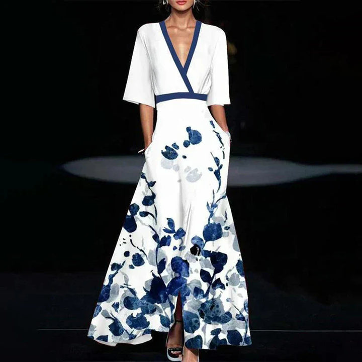 "Robe maxi longue élégante à imprimé floral vibrant, col en V et manches trois-quarts, tissu léger et respirant."
