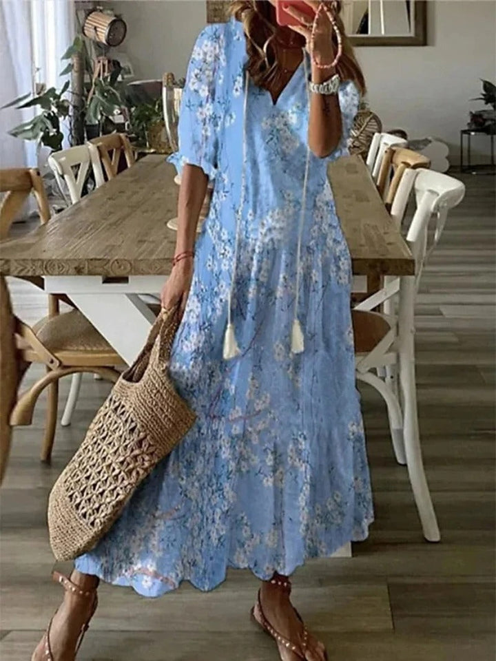 "Robe maxi vert bohème fluide, motifs élégants entrelacés, style chic et confortable, longueur au sol, tissu léger."
