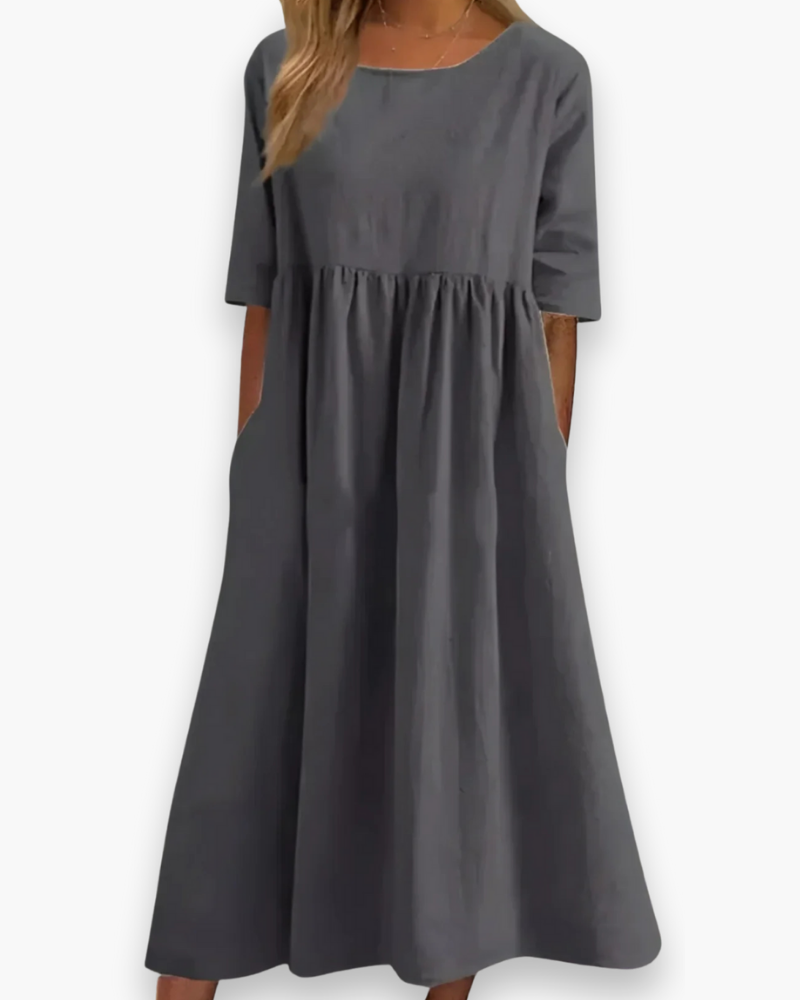 "Robe midi élégante et confortable pour femme, coupe fluide et détails soignés dans diverses couleurs disponibles."