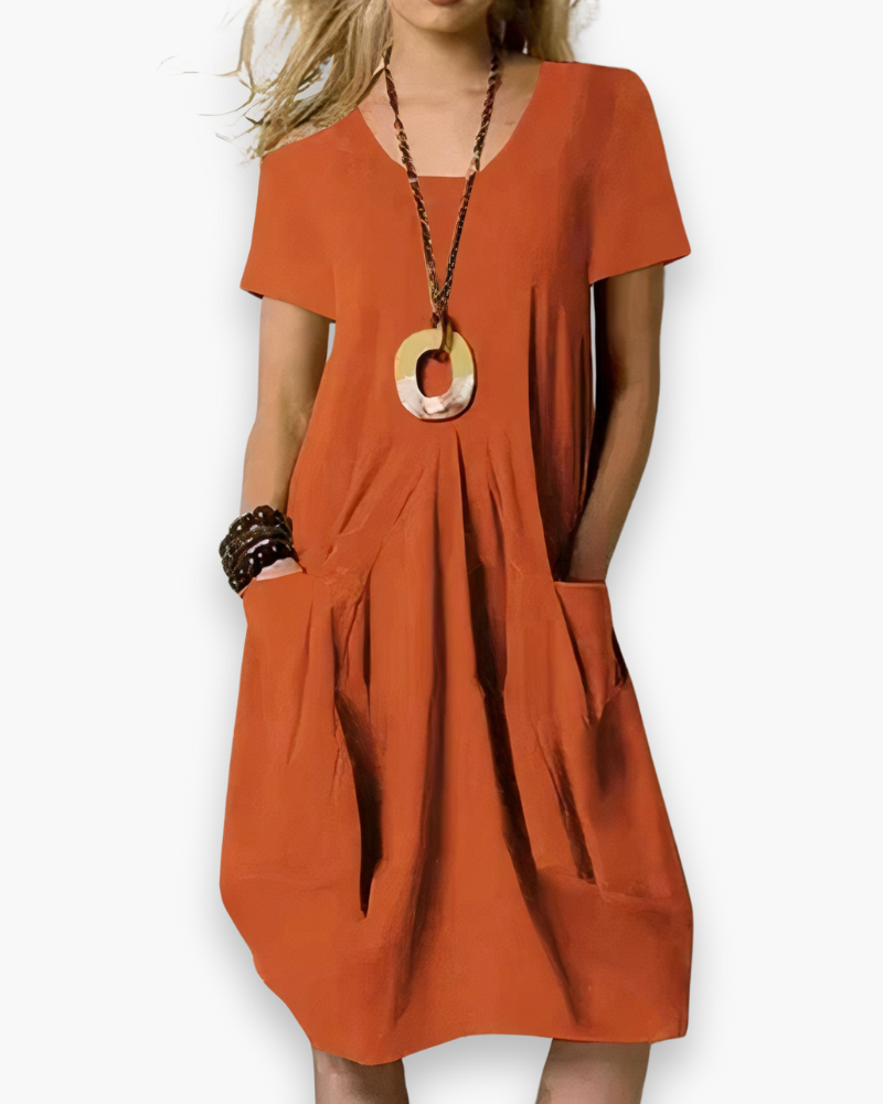 Robe midi femme élégante, ample et chic, tissu fluide avec poches, adaptable pour occasion décontractée ou sophistiquée.