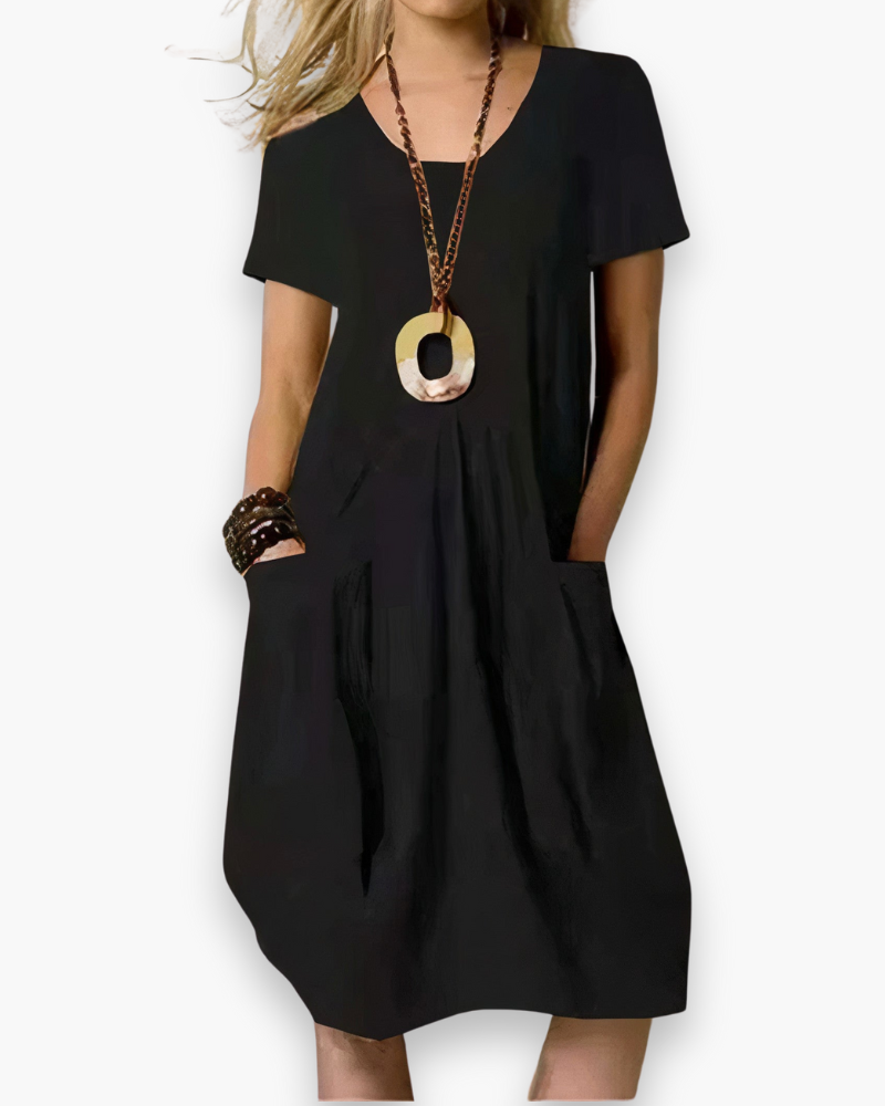 Robe midi femme élégante, ample et chic, tissu fluide avec poches, adaptable pour occasion décontractée ou sophistiquée.