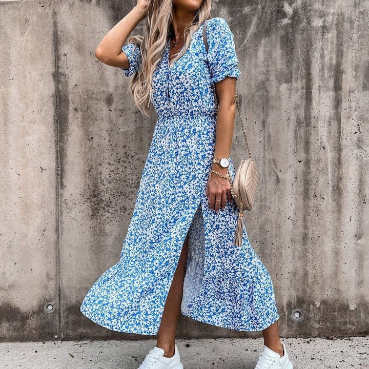 "Robe portefeuille tropicale midi avec motif vif, décolleté en V, manches courtes, ceinture ajustable et tissu léger."