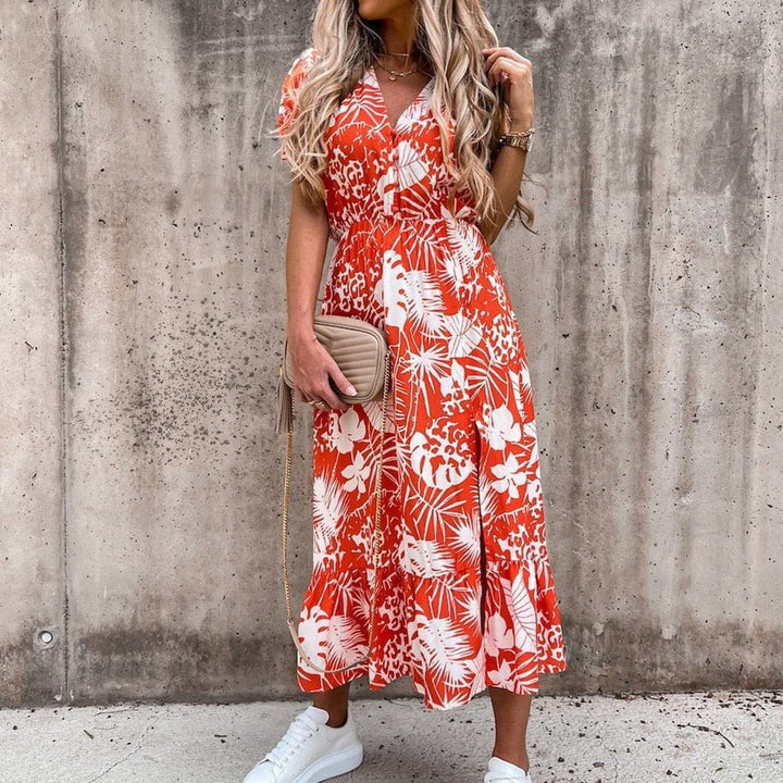 "Robe portefeuille tropicale midi avec motif vif, décolleté en V, manches courtes, ceinture ajustable et tissu léger."