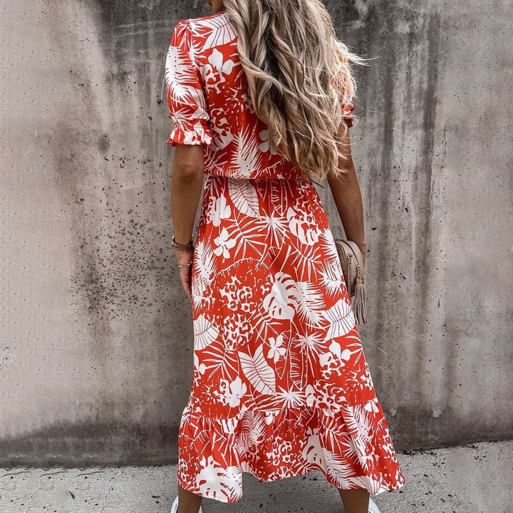 "Robe portefeuille tropicale midi avec motif vif, décolleté en V, manches courtes, ceinture ajustable et tissu léger."