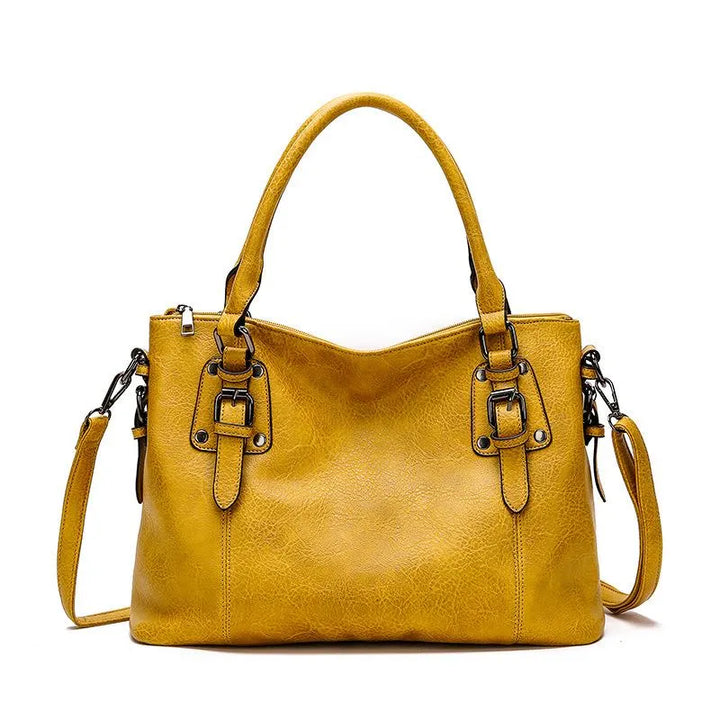 Sac à bandoulière en cuir véritable brun, élégant et résistant, avec sangle réglable pour un style chic et durable.