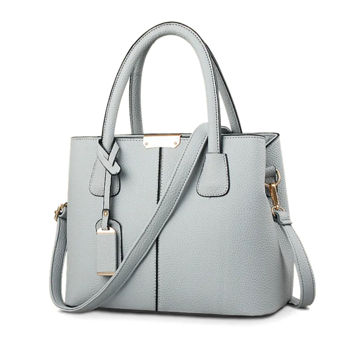 "Sac à bandoulière violet élégant et spacieux pour femme, avec sangle réglable et design intemporel, vue de face."