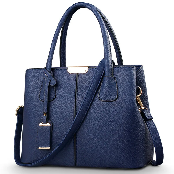 "Sac à bandoulière violet élégant et spacieux pour femme, avec sangle réglable et design intemporel, vue de face."