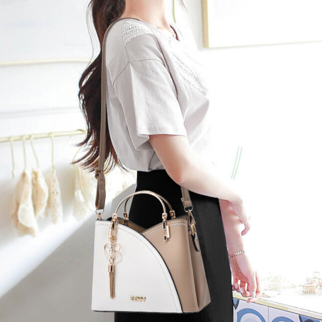 "Sac à main luxe en cuir brun et beige, silhouette élégante, détails raffinés, accessoire féminin moderne"