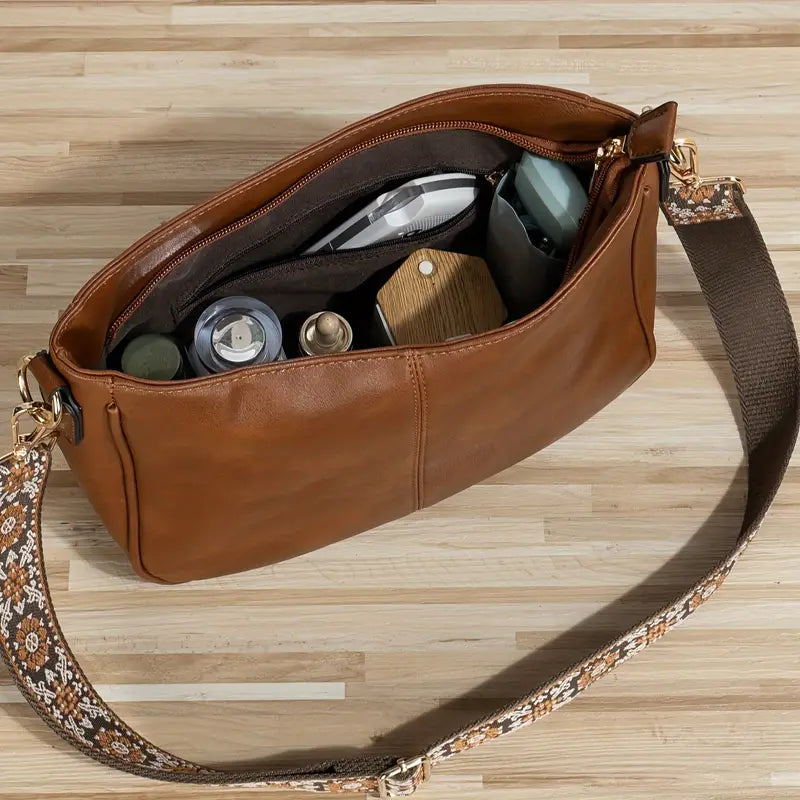 "Sac bandoulière en cuir végétalien Katelijne chic avec accents dorés, bandoulière ajustable et compartiments pratiques."