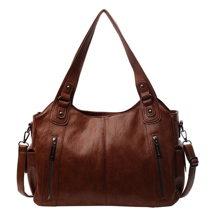 "Sac bandoulière femme Dakota en cuir synthétique, élégant, spacieux, bandoulière ajustable, vue de face, chic minimaliste"