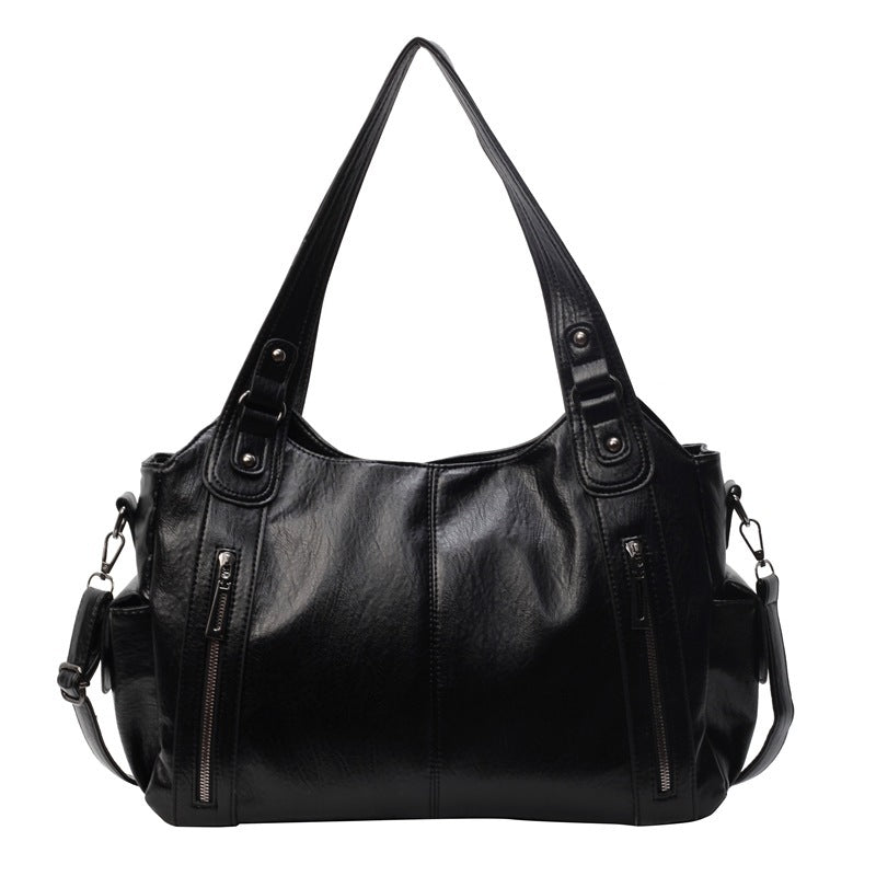 "Sac bandoulière femme Dakota en cuir synthétique, élégant, spacieux, bandoulière ajustable, vue de face, chic minimaliste"