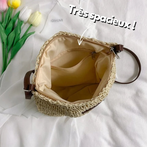 "Sac bandoulière Léandre en paille premium avec finitions cuir végan, bandoulière ajustable et fermeture éclair sécurisée."