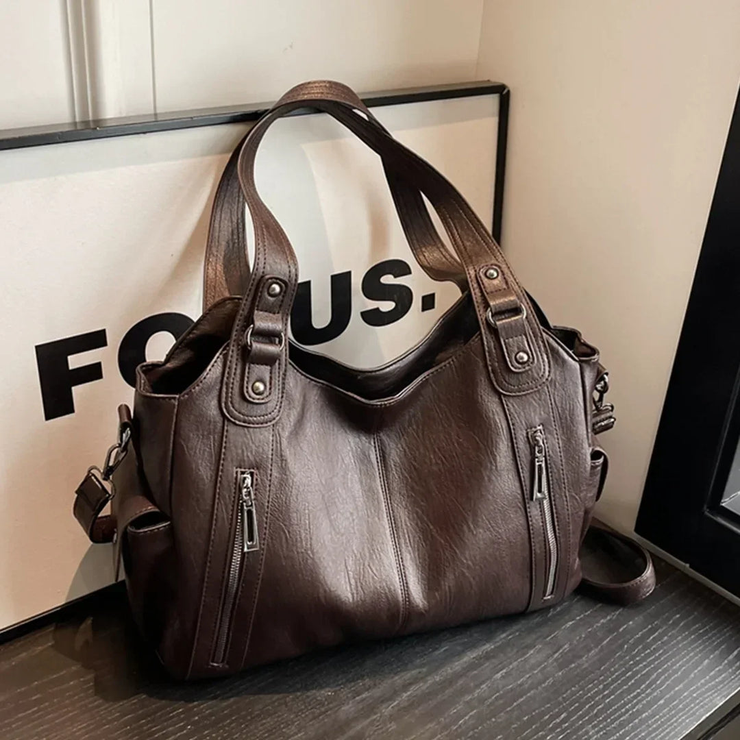 Sac d'école à bandoulière en cuir végétal lisse, design élégant, couleur classique, idéal pour femmes modernes.