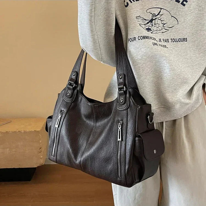 Sac d'école à bandoulière en cuir végétal lisse, design élégant, couleur classique, idéal pour femmes modernes.