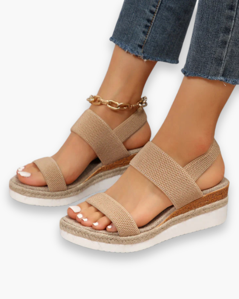 Sandales compensées élégantes pour femme, semelle haute et bride élastique, style chic idéal pour tenues estivales.