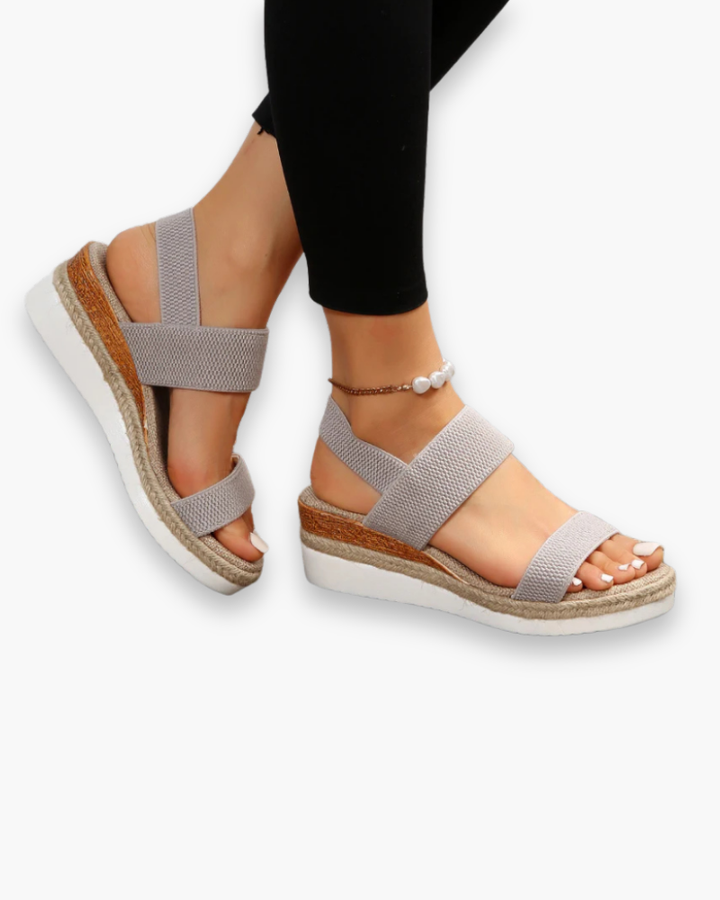 Sandales compensées élégantes pour femme, semelle haute et bride élastique, style chic idéal pour tenues estivales.