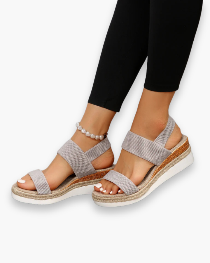 Sandales compensées élégantes pour femme, semelle haute et bride élastique, style chic idéal pour tenues estivales.