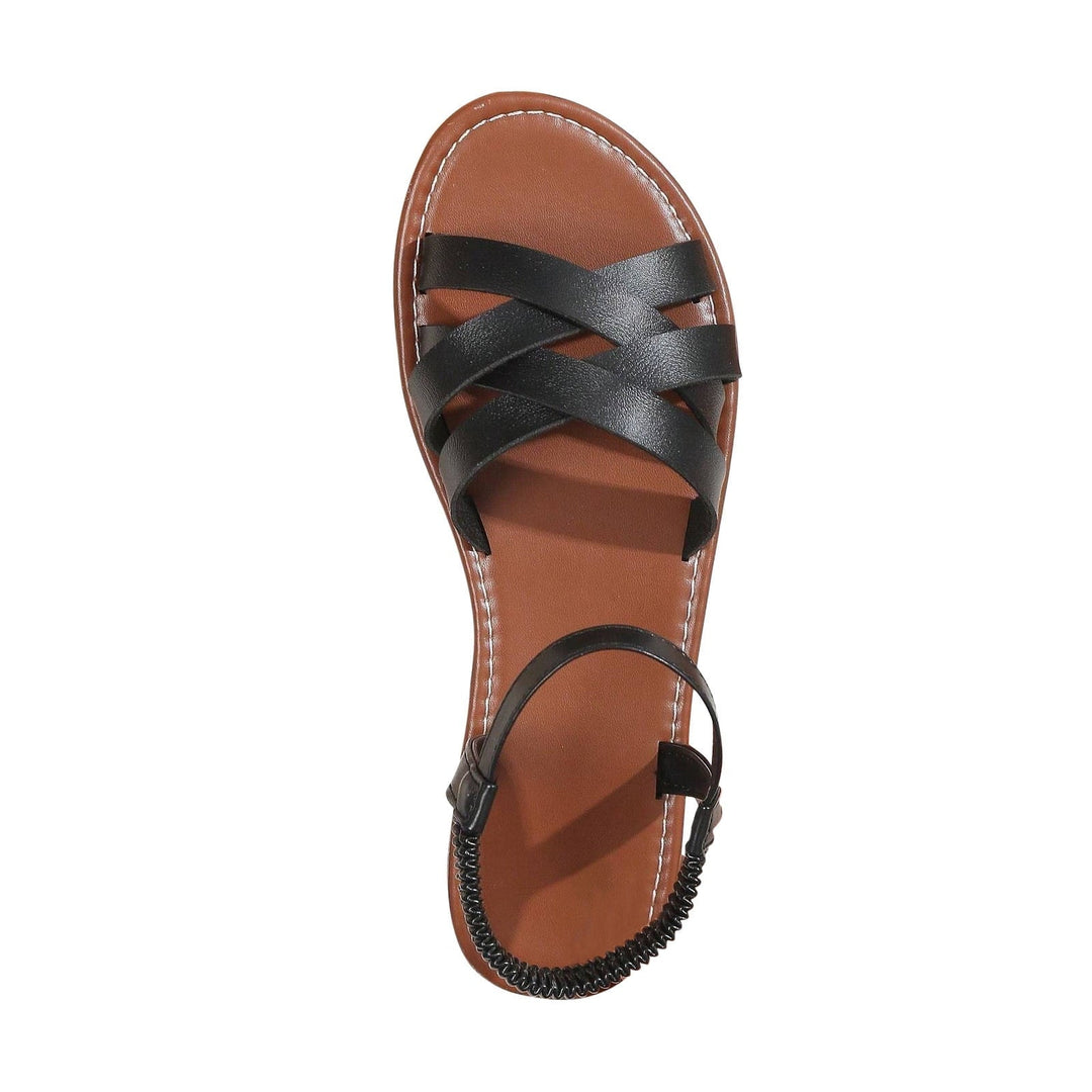 "Sandales plates femme à bandes croisées, couleur beige, idéales pour l'été, offrant confort et élégance pour la plage."