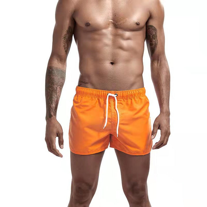 Short de bain homme bleu, tissu extensible, séchage rapide, vue avant, élégant et confortable pour plage ou piscine.