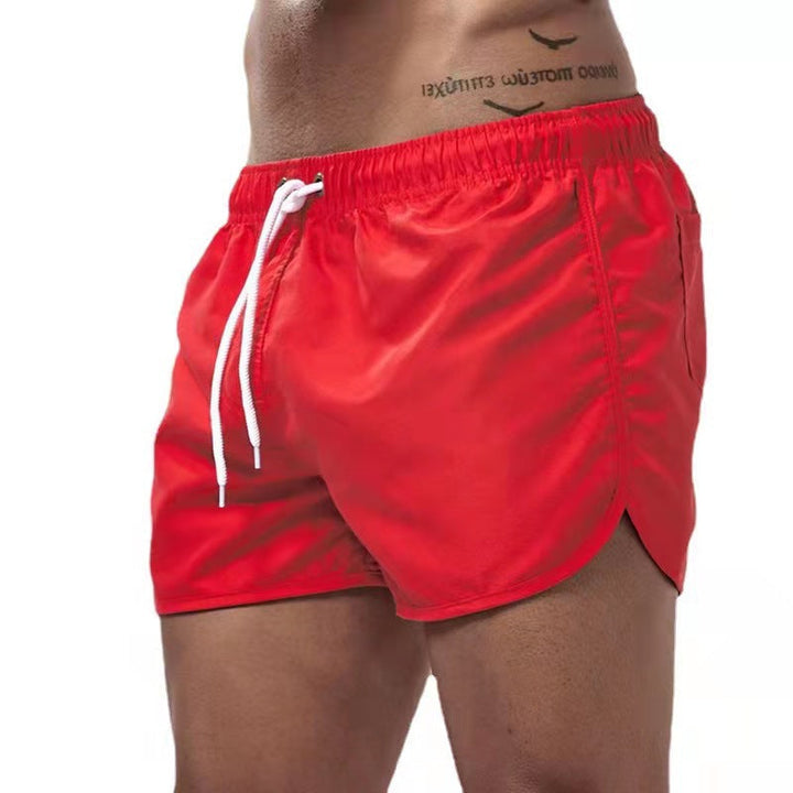 Short de bain homme bleu, tissu extensible, séchage rapide, vue avant, élégant et confortable pour plage ou piscine.