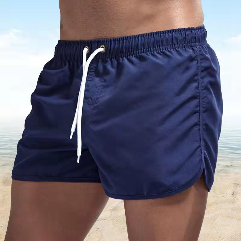 Short de bain homme bleu, tissu extensible, séchage rapide, vue avant, élégant et confortable pour plage ou piscine.
