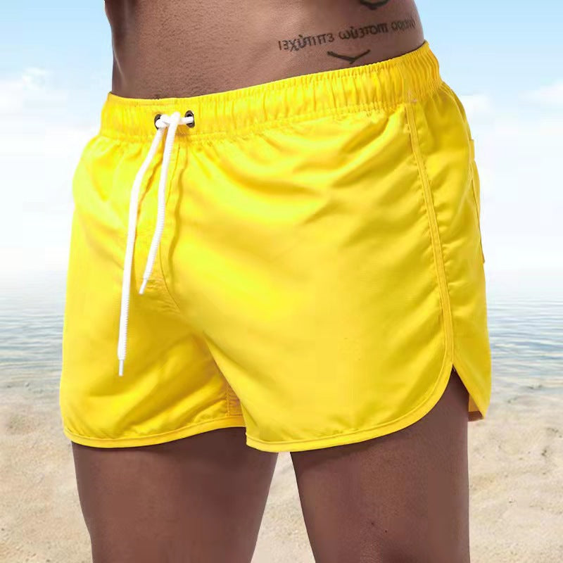 Short de bain homme bleu, tissu extensible, séchage rapide, vue avant, élégant et confortable pour plage ou piscine.