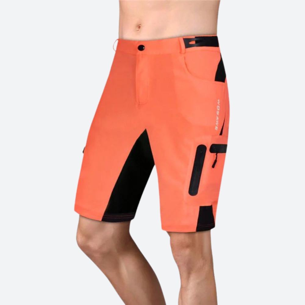 Short technique homme bleu, déperlant, poches zippées, tissu respirant, coupe ergonomique, idéal randonnée et cyclisme.
