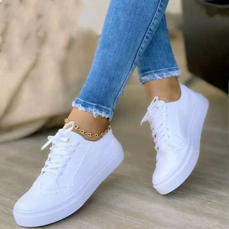 Sneakers orthopédiques élégantes pour femme en cuir blanc, avec semelle de soutien confortable et design moderne.
